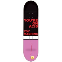 Toy Machine Acid skateboard deck: Bold red block capitals on a black upper half read 'You're on acid, Toy Machine', above a row of white blocks. The lower half is pink, like a giant pill or tongue, with a faint curved line and a small yellow logo at the tail.
