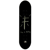 Foundation KOR Gold Foil skateboard deck: Rough hand-drawn grey cross shape with short radiating lines above handwritten text on a black deck, with a small logo at the base.