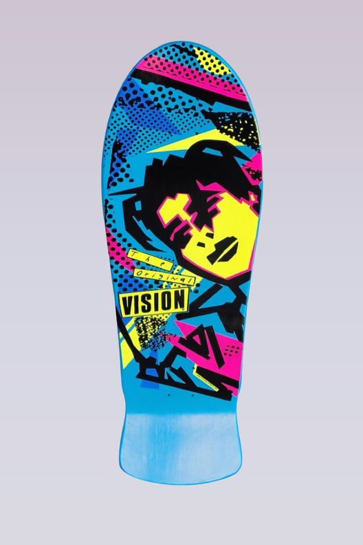 Vision Street Wear "Double Take" MG - Blue Solid skateboard deck: Old-school shaped deck with a stylised, fragmented black, yellow and pink face in a pop-art style over a blue background with halftone dots and angular shapes. A Vision label reads 'The Original'.