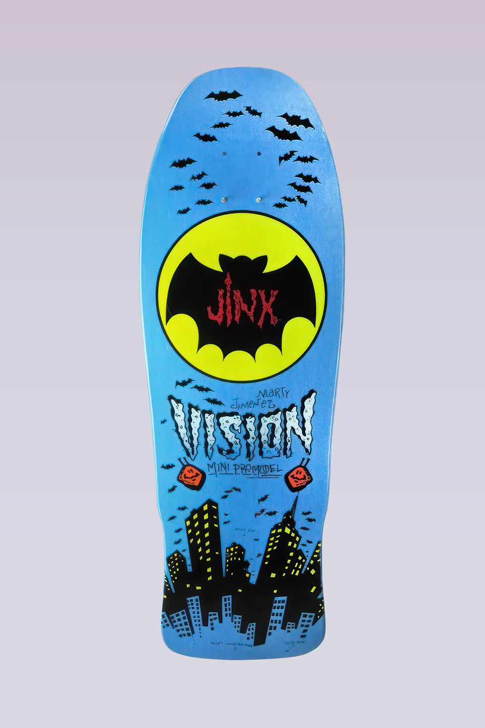 Vision Street Wear Jinx - Mini Modern Concave - Blue skateboard deck: Yellow bat-signal circle holding a black bat with Jinx in red lettering, surrounded by swarming bats above a black city skyline. Hand-drawn Vision lettering with Marty Jimenez and Mini Pro Model on a metallic blue deck.
