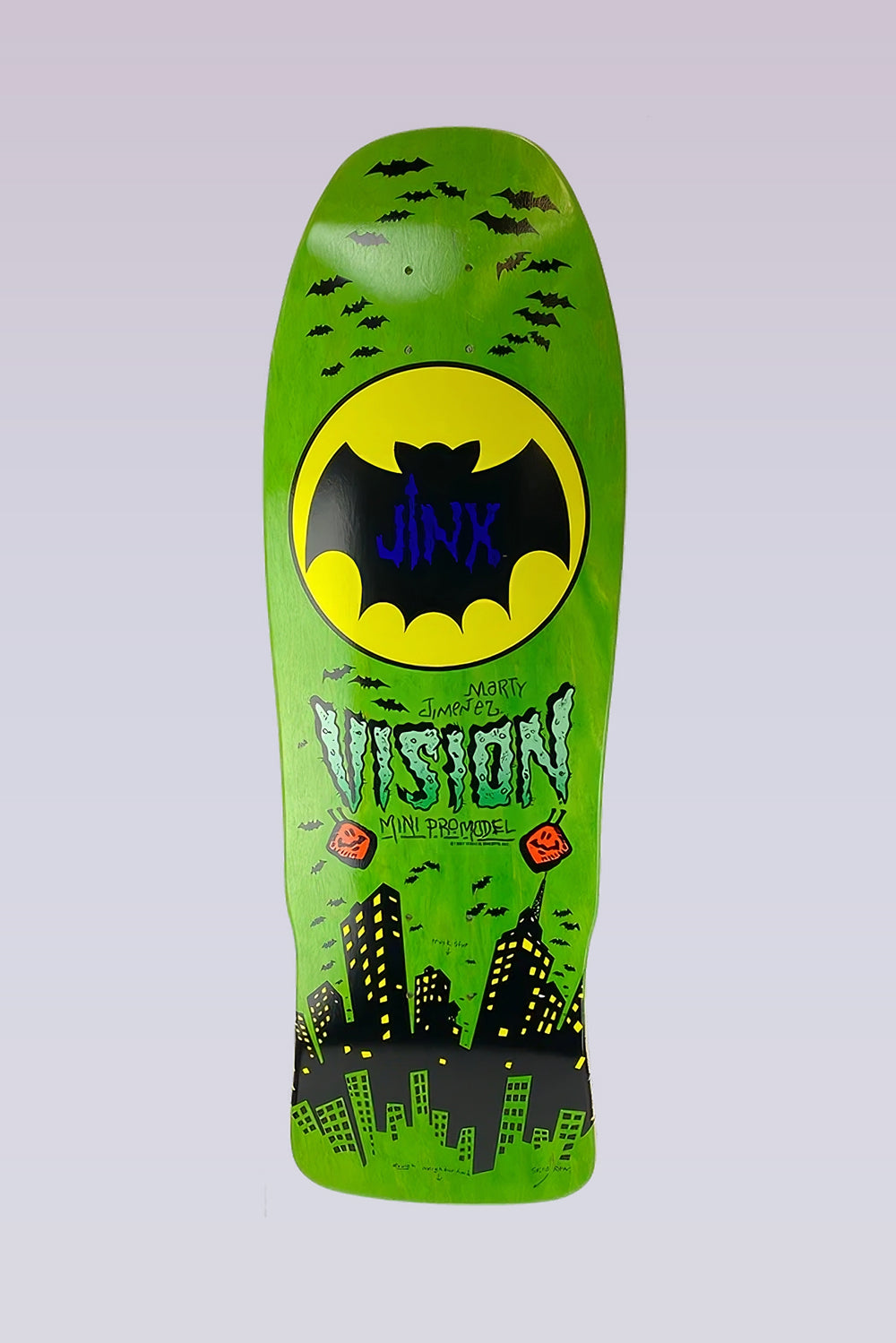 Vision Street Wear Jinx - Mini Modern Concave - Lime Stain skateboard deck: A large yellow circle containing a black bat with Jinx written on it, surrounded by swarms of small bats, above a night city skyline with lit windows. Vision Marty Jimenez Mini Pro Model lettering in dripping green type.