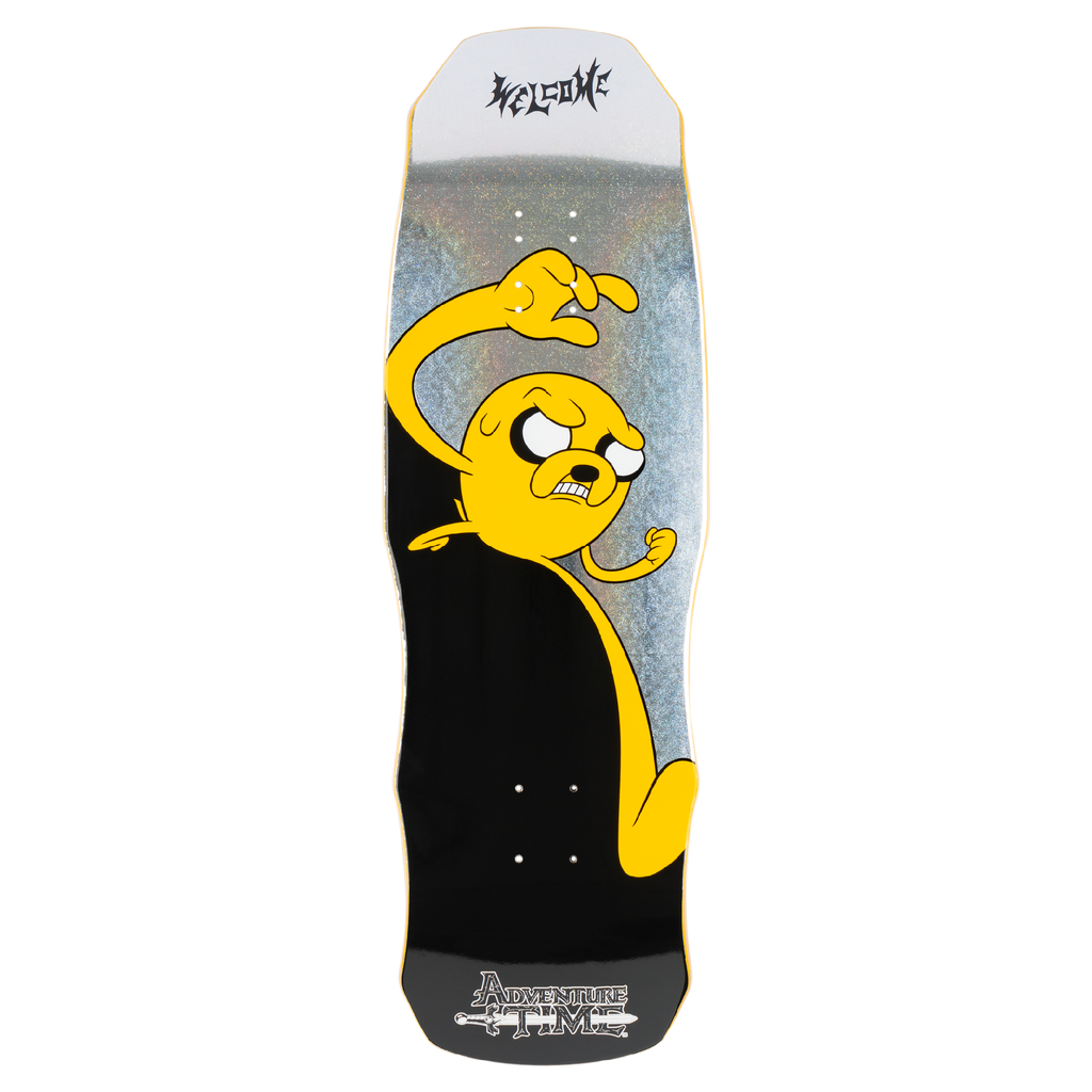 Welcome ADVENTURE TIME X WELCOME - Jake on Dark Lord skateboard deck: Adventure Time's yellow dog Jake with a scowl and one arm raised to strike, on a shaped deck with a holographic silver upper half and black lower half. Gothic Welcome logo at the top and Adventure Time logo at the tail.