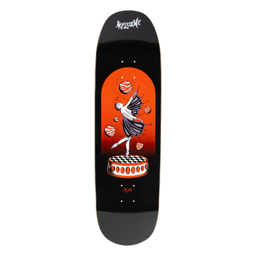 Welcome Ryan Reyes Dancer on Baculus 2.0 - Black skateboard deck: A winged ballerina in a dark tutu balances on one pointe on a checkerboard-topped round plinth, surrounded by floating striped orange planets in an arched red-orange panel on a black board, with a gothic Welcome logo above and 'Reyes' below.