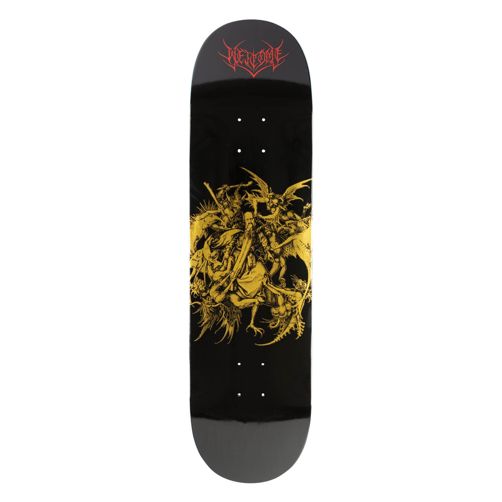 Welcome Saint on Popsicle - Black/Gold Foil skateboard deck: A dense gold-foil engraving of a robed saint beset by winged demons and monsters sits in the centre of a glossy black deck, with a red gothic Welcome logo near the nose.