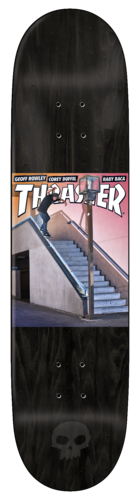 Zero Thrasher Cover - Burman skateboard deck: Black stained deck with a Thrasher magazine cover recreated mid-deck, showing a skater doing a board slide down a long handrail beside concrete steps. Small Zero skull logo at the tail.