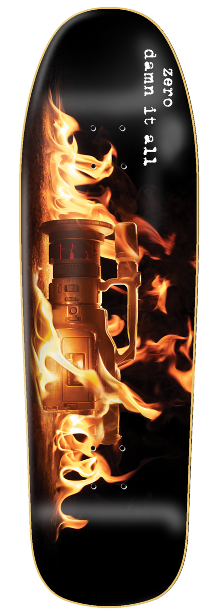Zero Damn It All - Vx 9.5 Cruiser skateboard deck: Shaped cruiser deck with a video camcorder engulfed in flames on a black background. The words 'zero damn it all' run down the top in white typewriter text.
