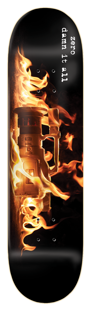 Zero Damn It All - Vx skateboard deck: A photograph of a video camcorder engulfed in flames on a black deck. White typewriter-style text runs down the upper part.