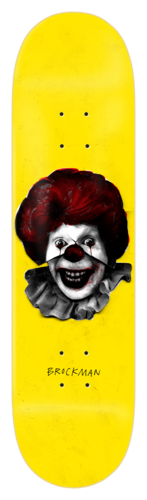 Zero Iconoclash - Brockman skateboard deck: Greyscale photographic-style image of a grinning clown with a red wig, red nose and ruffled collar, in a fast-food mascot style, on a plain yellow deck. Rider surname in small handwritten type below.