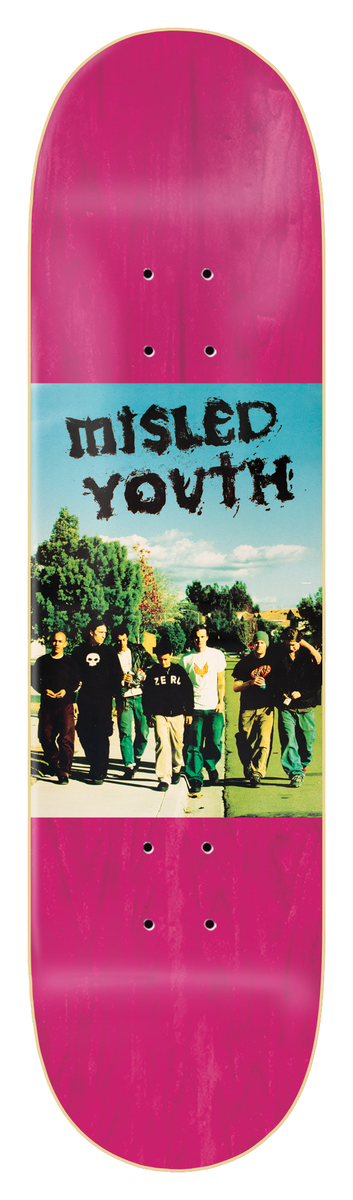 Zero Misled Youth 8.25 - Pink skateboard deck: Colour photo panel across the middle of a pink-stained deck showing a group of young men in dark clothes walking along a path past trees under a blue sky, with Misled Youth in a scratchy black hand-drawn font above them.