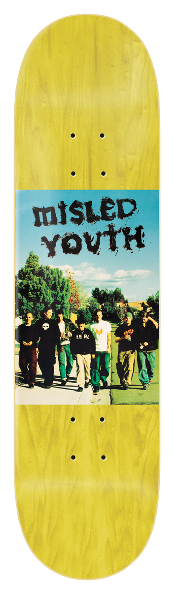Zero Misled Youth 8.25 - Yellow skateboard deck: Colour photo panel across the middle of a yellow-stained deck showing a group of young men in dark clothes walking along a path past trees under a blue sky, with Misled Youth in a scratchy black hand-drawn font above them.