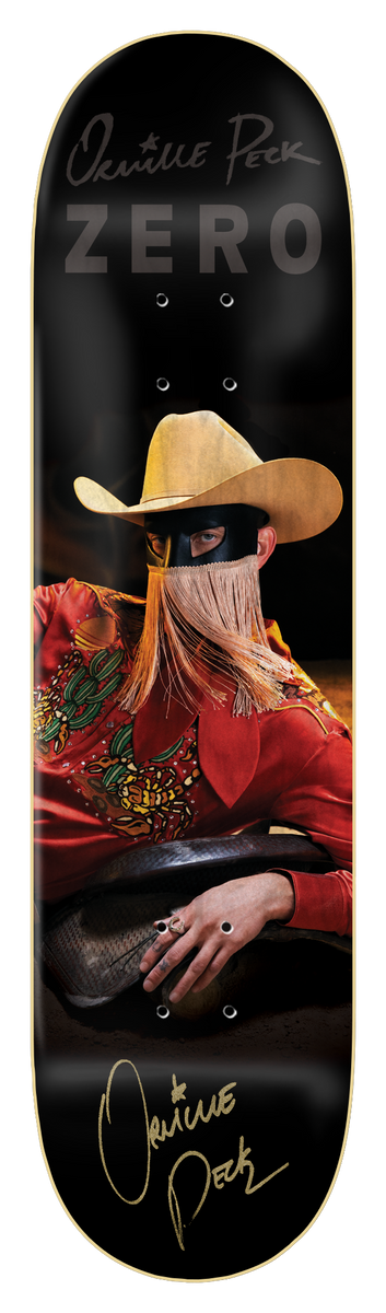 Zero Orville Peck - Bronco *signed* skateboard deck: A photographic portrait of a masked figure in a cream cowboy hat with a long fringe over the face, wearing a red embroidered western shirt and resting on a saddle. Gold signature and name printed above and below on a black deck.