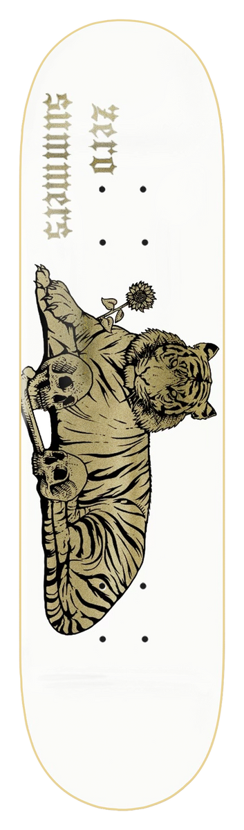 Zero Summers - Tiger 8.4 skateboard deck: A gold-printed tiger lies down with its paws resting on two skulls and a flower in its mouth, on a white deck. Gothic lettering with the rider name and Zero runs upside down near the nose.