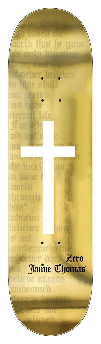 Zero Thomas - Foil Cross 8.25 skateboard deck: A white cross over faint blackletter Bible text (John 3:16) on a gold foil deck, with gothic name text near the tail.