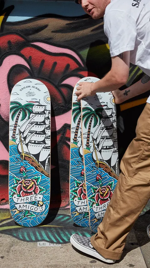 The Sailor Jerry × Steen Jones decks against the mural by Three Amigos collabs