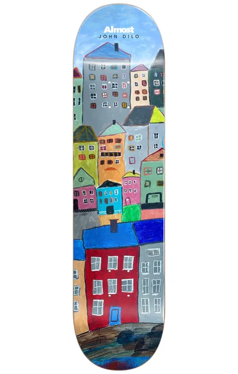 Almost Dilo Places R7 LEFT 8.125 skateboard deck: Naive painted townscape of colourful houses stacked up a hillside, with tiny windows, against a blue sky. A red house with a blue door sits in the foreground. Almost logo and John Dilo name at the top.