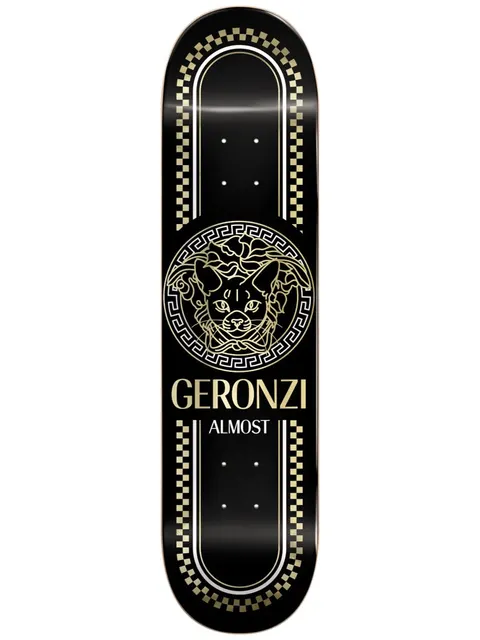 Almost Max Luxury Super Sap R7 8.5 skateboard deck: Gold line-art cat's head inside a Greek-key medallion in the style of a luxury fashion logo, with gold chequered borders on a black deck, and rider name and brand in gold below.
