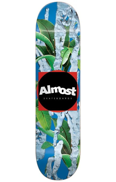 Almost Metal HYB 8.125 Blue skateboard deck: Large green tropical leaves on a blue ground with silvery-grey dripping metallic forms running down the deck, with a black circle in a red square holding the Almost Skateboards logo at the centre.