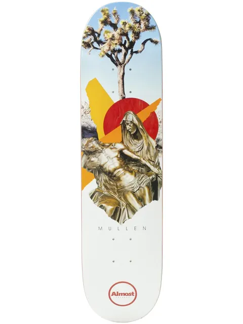 Almost Mullen Cut & Paste R7 7.75 skateboard deck: Collage of a Joshua tree against blue sky above a gilded Pieta statue, set over a red sun disc and orange and yellow slashes on a white deck. Rider name and Almost logo below.