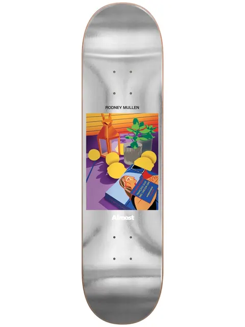 Almost Mullen Life Stills Impact Light 8 skateboard deck: A flat, stylised still-life painting in a square panel, with a lantern, lemons, a potted plant and a book with a woman's portrait on its cover. The deck is a brushed silver foil with the rider name above.