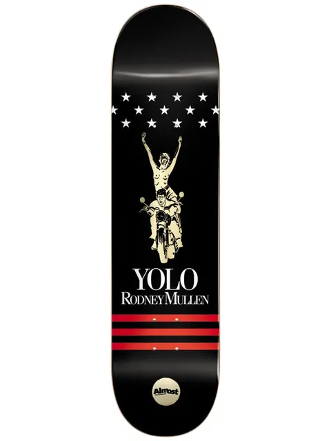 Almost Mullen Luxury Super Sap R7 7.75 skateboard deck: A cream line drawing of a nude woman raising her arms while riding pillion on a motorcycle with a male rider, below a row of white stars. 'YOLO Rodney Mullen' and three red stripes sit below on a black deck.