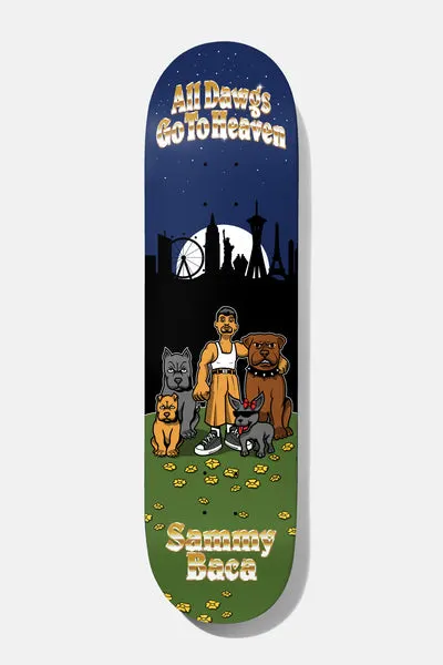 Baker Baca All Dawgs Go To Heaven 8.5 skateboard deck: Cartoon scene of a man in an orange kilt and white vest standing with four dogs on a grass field dotted with paw prints, in front of a night skyline with a Ferris wheel and landmarks under a full moon. Gold lettering at top and bottom.