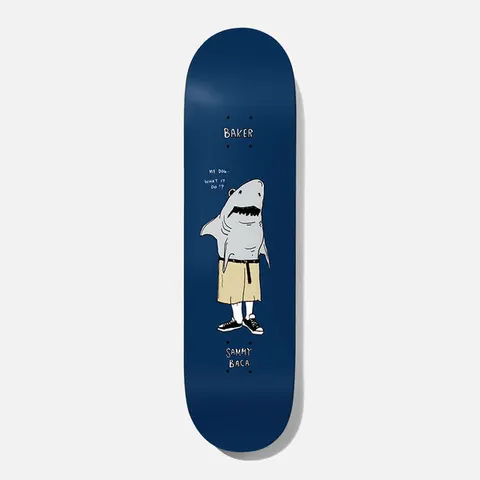Baker Baca What It Do 8.125 skateboard deck: A cartoon shark standing upright in khaki shorts, white socks and black trainers, with a speech bubble asking what it do, on a navy deck. Baker at the nose and the rider name at the tail in hand lettering.