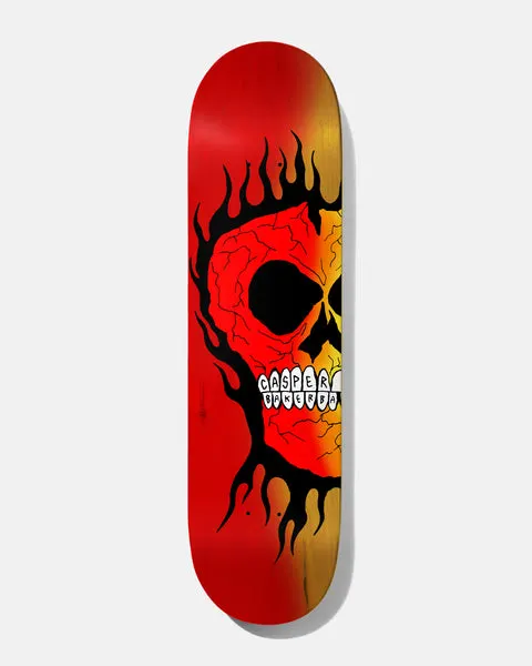 Baker Casper Rasta Skull B2 8.5 skateboard deck: A large cracked, veiny skull in black outline with flames licking round it, fading from red to yellow-orange across the deck. The teeth spell out Casper and Baker.