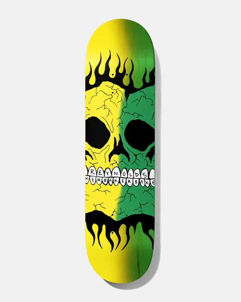 Baker Reynolds Rasta Skull B2 8.38 skateboard deck: A large cracked skull outlined in black, with flames around it, split down the middle between yellow and green, with the teeth spelling out Reynolds and Baker.