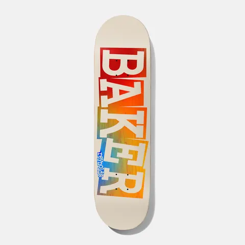 Baker Reynolds Ribbon Tan Rainbow 8.5 skateboard deck: Large cream block-serif BAKER letters in a ribbon-cut style reveal a rainbow gradient of red, orange, yellow and blue behind them on a cream deck, with small blue reynolds lettering by the tail.