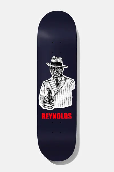 Baker Reynolds Take the Cannoli 8.5 skateboard deck: Black-and-white inked gangster in a fedora and pinstripe suit pointing a revolver at the viewer, on a navy deck with REYNOLDS in red lettering below.