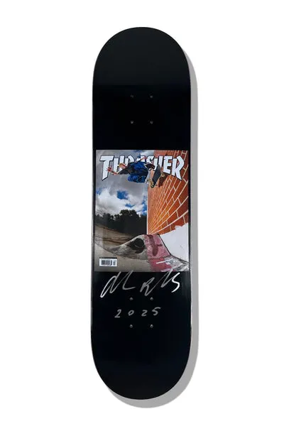 Baker Reynolds Thrasher Cover 8.25 (Signed) skateboard deck: Black deck with a small panel styled as a Thrasher magazine cover, showing a skater in blue mid-air over a brick wall and gap, with a barcode. A silver signature and 2025 are written beneath.