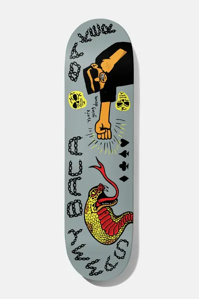 Baker Sammy Baca Going Down 8.25 skateboard deck: Sunglasses-wearing man in black punching with a fist, with yellow skulls, card suits and a yellow and red snake, plus chain-link lettering of the rider name, on grey.