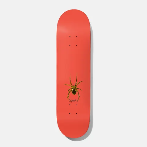 Baker Spanky Eraser Head 8.25 skateboard deck: Small gold-brown spider near the tail of a plain coral-red deck, with the rider name 'Spanky' handwritten beneath it.