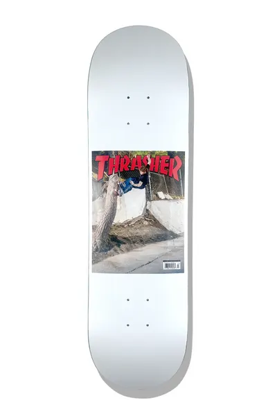 Baker T - Funk Thrasher Cover 8.5 skateboard deck: White deck carrying a reproduction of a Thrasher magazine cover, with a red Thrasher logo above a photograph of a skater doing a trick off a tree beside a fenced concrete bank, and a barcode at the lower right.