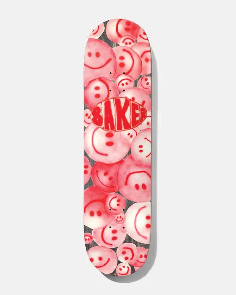 Baker Theotis Nozzle Clog 8.25 skateboard deck: Cluster of overlapping spray-painted smiley faces in pink and red over a greyish wood-grain background, with a hand-sprayed red Baker logo in an oval at the centre.
