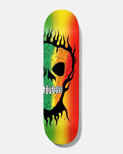 Baker Tyson Rasta Skull B2 8.25 skateboard deck: Half a cracked skull with flaming black outline sits on the left of a green, yellow and red rasta-striped deck, with the teeth spelling Tyson Baker.