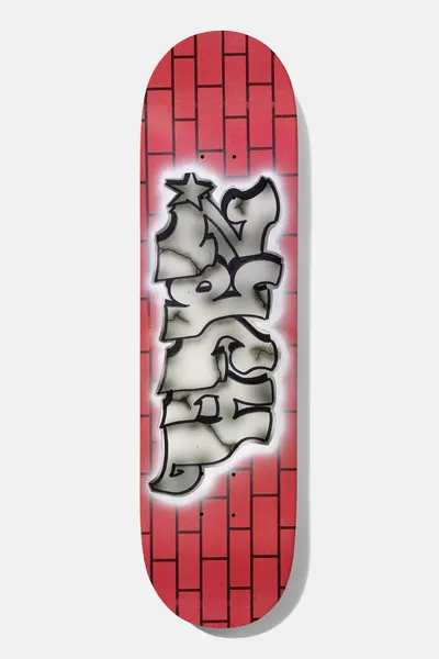 Baker Zach Brickhouse 8.25 skateboard deck: Graffiti-style throw-up lettering with a star, in cracked grey and white with black outlines and a white airbrushed glow, over a red brick wall pattern.