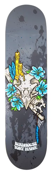Birdhouse Tony Hawk Shrine skateboard deck: An animal skull topped with dripping yellow candles, ringed with blue flowers, a bone, a blue feather and cobweb, on a grey background with black paint splatters.