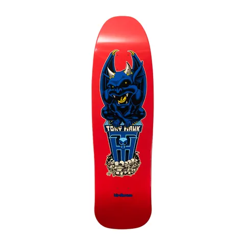 Birdhouse Hawk Gargoyle Old School 9.375 skateboard deck: A crouching blue gargoyle with horns and wings perched on a blue pedestal bearing a skull and the name, above a pile of skulls. On a red old-school shaped deck with small Birdhouse text at the tail.