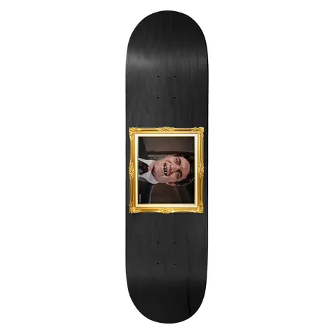 Birdhouse Jaws Golden Fried 8.25 skateboard deck: Black stained deck with a gold ornate picture frame in the centre, containing a photo of a smiling man in a suit wearing a metal grill over his teeth.