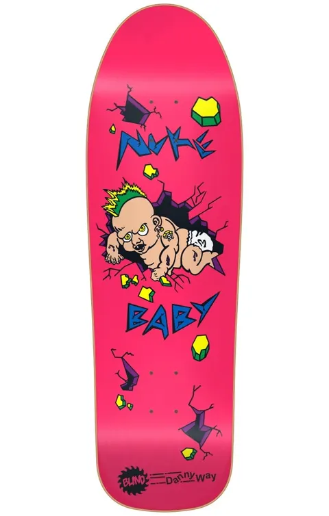 Blind Danny Way Nuke Baby SP PINK R7 9.7 skateboard deck: A cartoon mutant baby with a green mohawk and earrings bursts through a cracked wall, surrounded by yellow-green rubble. Jagged blue 'Nuke Baby' lettering is on a hot pink deck, with a Blind logo and Danny Way name at the tail.