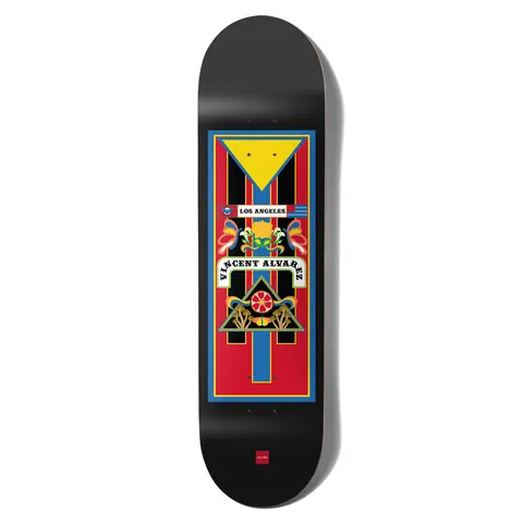 Chocolate Alvarez Trajineras skateboard deck: A rectangular decorative panel in red, blue, yellow and black with a yellow triangle, floral and bird motifs, a Los Angeles banner and the rider name on a curved scroll, set on a black deck.