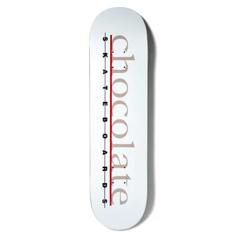 Chocolate Anderson Bar Logo skateboard deck: White deck with the word chocolate in large taupe serif lowercase letters down the length, crossed by a red line, with spaced black SKATEBOARDS lettering alongside.