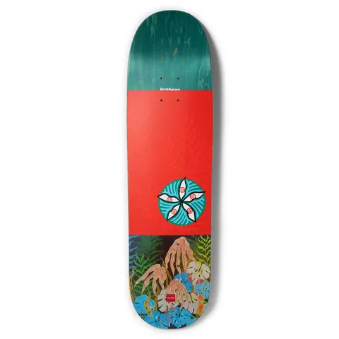 Chocolate Anderson Dog Perfume Skidul skateboard deck: Teal-stained top section, a red-orange middle with embossed fern pattern and a round teal medallion of five white eyes or petals. The base shows a painted jungle of leaves and tangled pink roots. Signature at the top and Chocolate logo at the bottom.