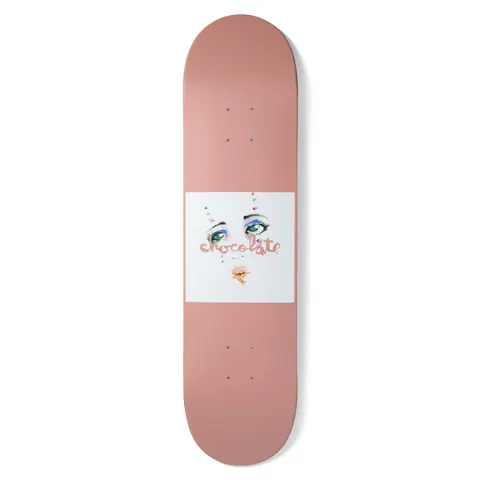 Chocolate Anderson Dream Rodeo skateboard deck: Plain dusty-pink deck with a white square at the centre showing a painted face of green eyes with colourful eyeshadow and lips, overwritten by the pink Chocolate script logo.