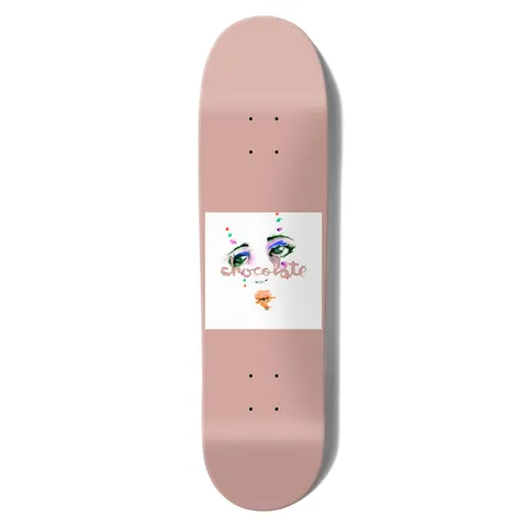 Chocolate Anderson Dream Rodeo Skidul skateboard deck: Plain dusty pink deck with a white square in the centre showing a painted woman's face, with only eyes and mouth visible, and dots of colour. Chocolate logo in pink script across it.