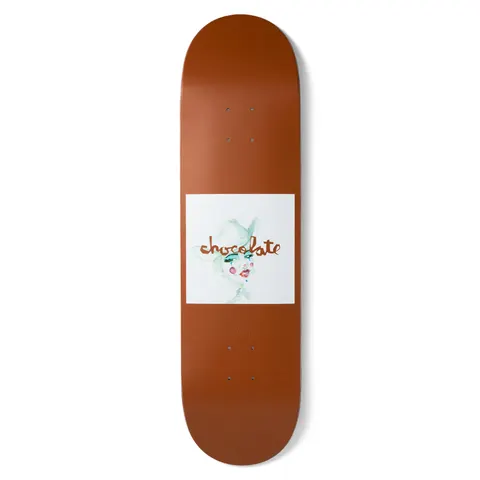 Chocolate Fernandez Dream Rodeo skateboard deck: Rust-brown deck with a white square panel holding a loose watercolour portrait of a woman in a hat with green eye shadow and pink cheeks, with the Chocolate script logo across it.