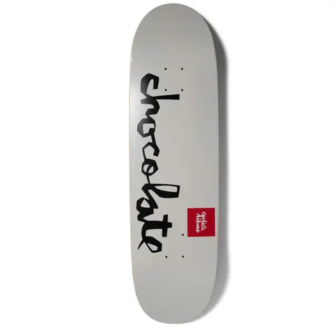 Chocolate Aikens OG Chunk Loveseat+ skateboard deck: Plain light grey wide-nosed deck with the large black brush-script Chocolate logo running down the length, plus a small red square name label to the right.