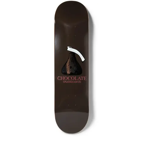 Chocolate Alvarez Kiss skateboard deck: A chocolate kiss sweet with a white paper tag on a plain dark brown deck, with 'CHOCOLATE skateboards' in pink beneath. Tag carries small typed text.