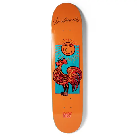 Chocolate Brenes Nicaraguan Sunrise (Signed) skateboard deck: Folk-art style red rooster crowing beneath a smiling sun with rays, framed in a teal rectangle on an orange deck. A black printed signature sits at the top.
